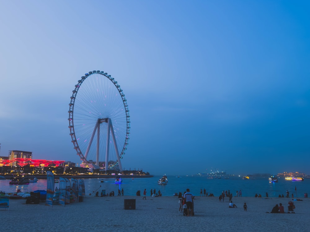 a large ferris wheel sitting on top of a sandy beach