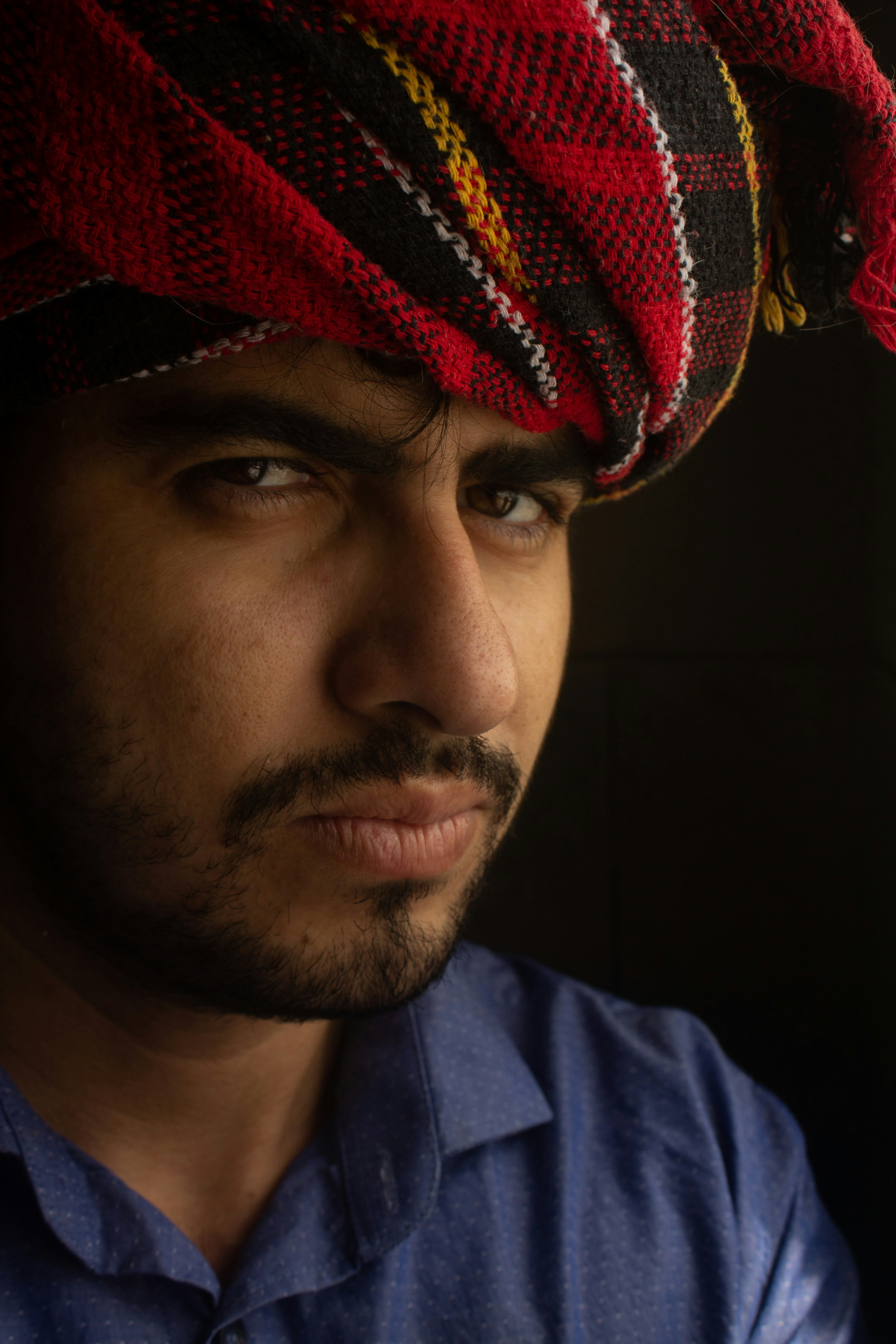 a man wearing a red and black striped hat