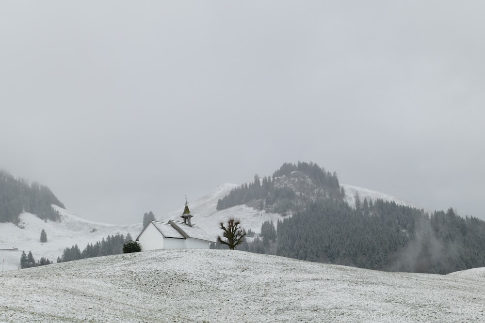 a snow covered hill with a church on top of it