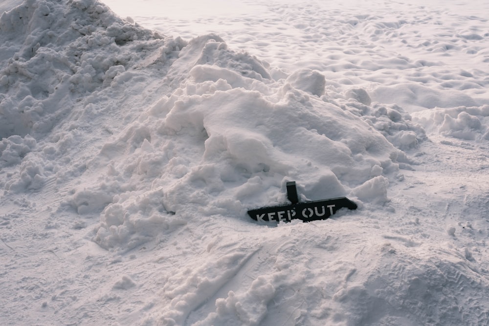 a sign that is laying in the snow