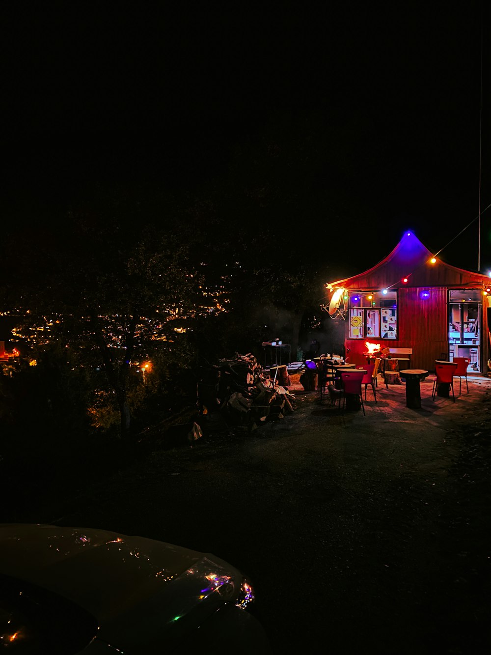 a red house with a blue roof at night