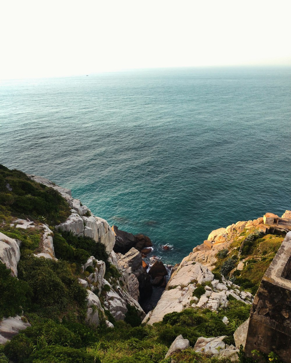 a view of the ocean from the top of a hill