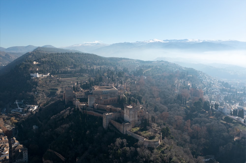 an aerial view of a castle in the mountains