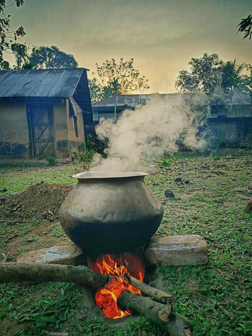 a large pot sitting on top of a fire pit