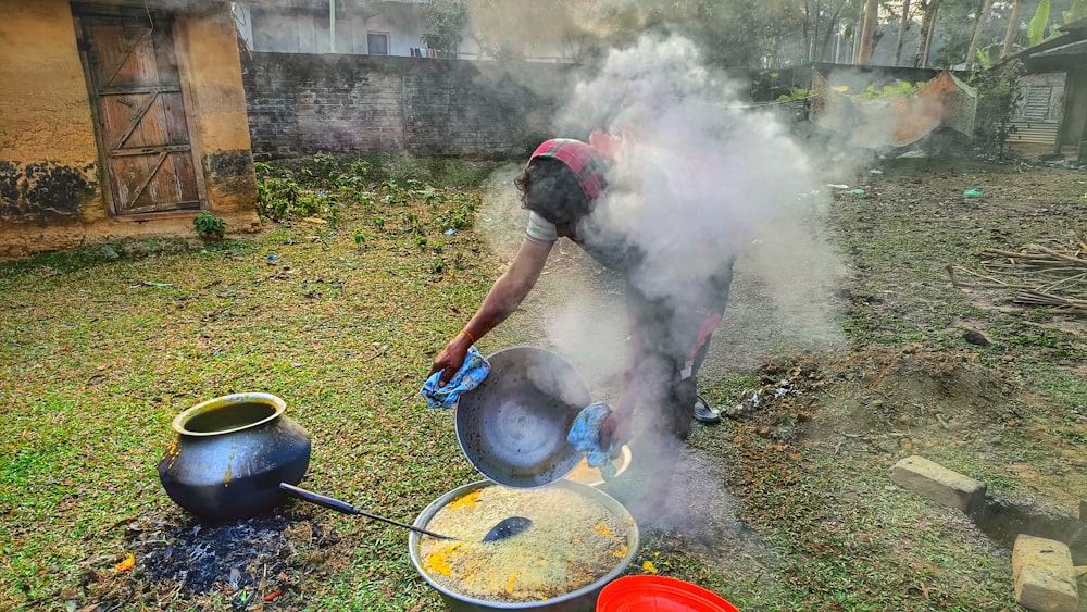 a woman is cooking food on a stove