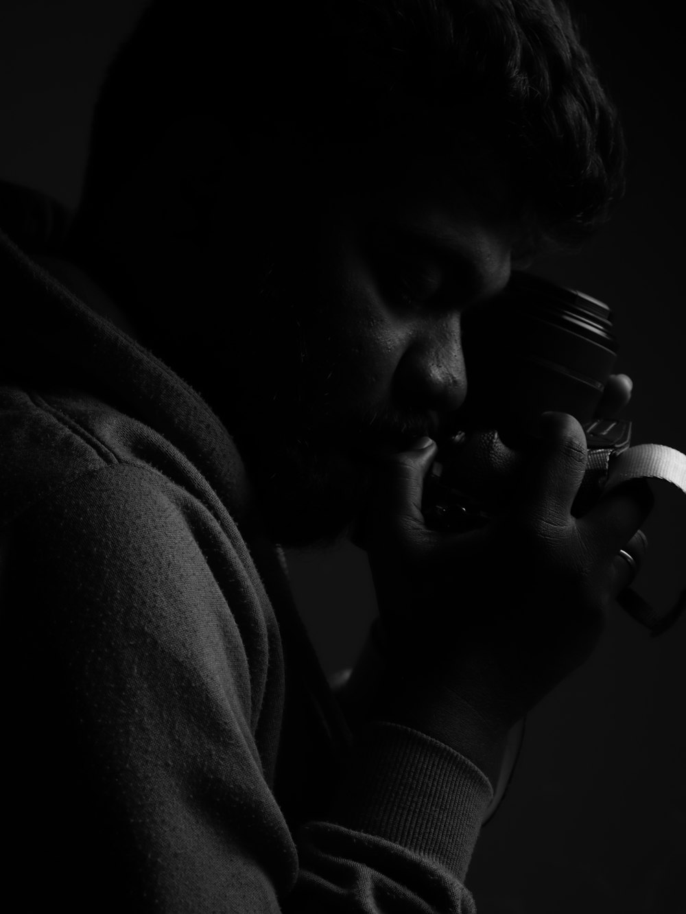 a man holding a camera up to his face