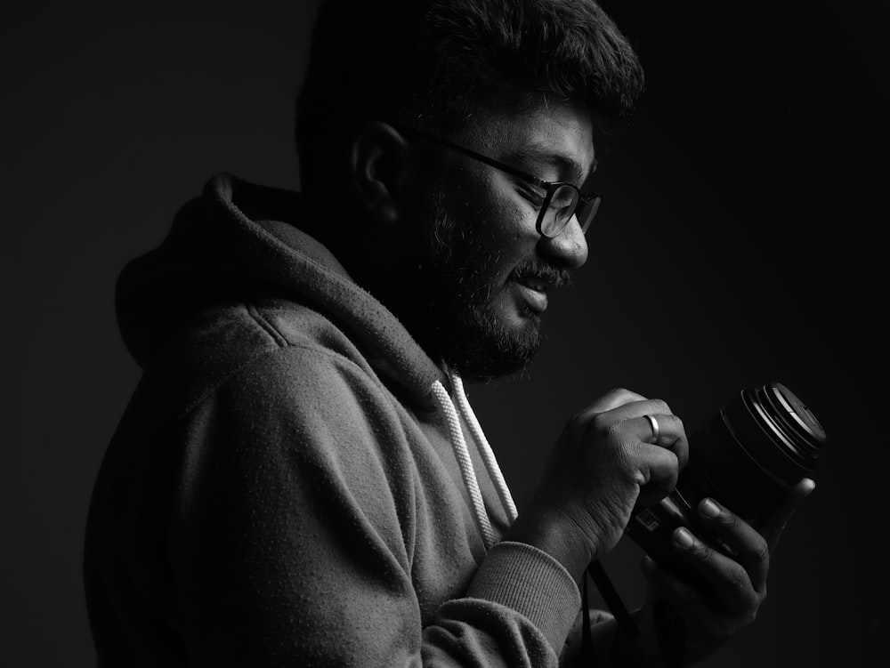 a man in a hoodie is holding a jar