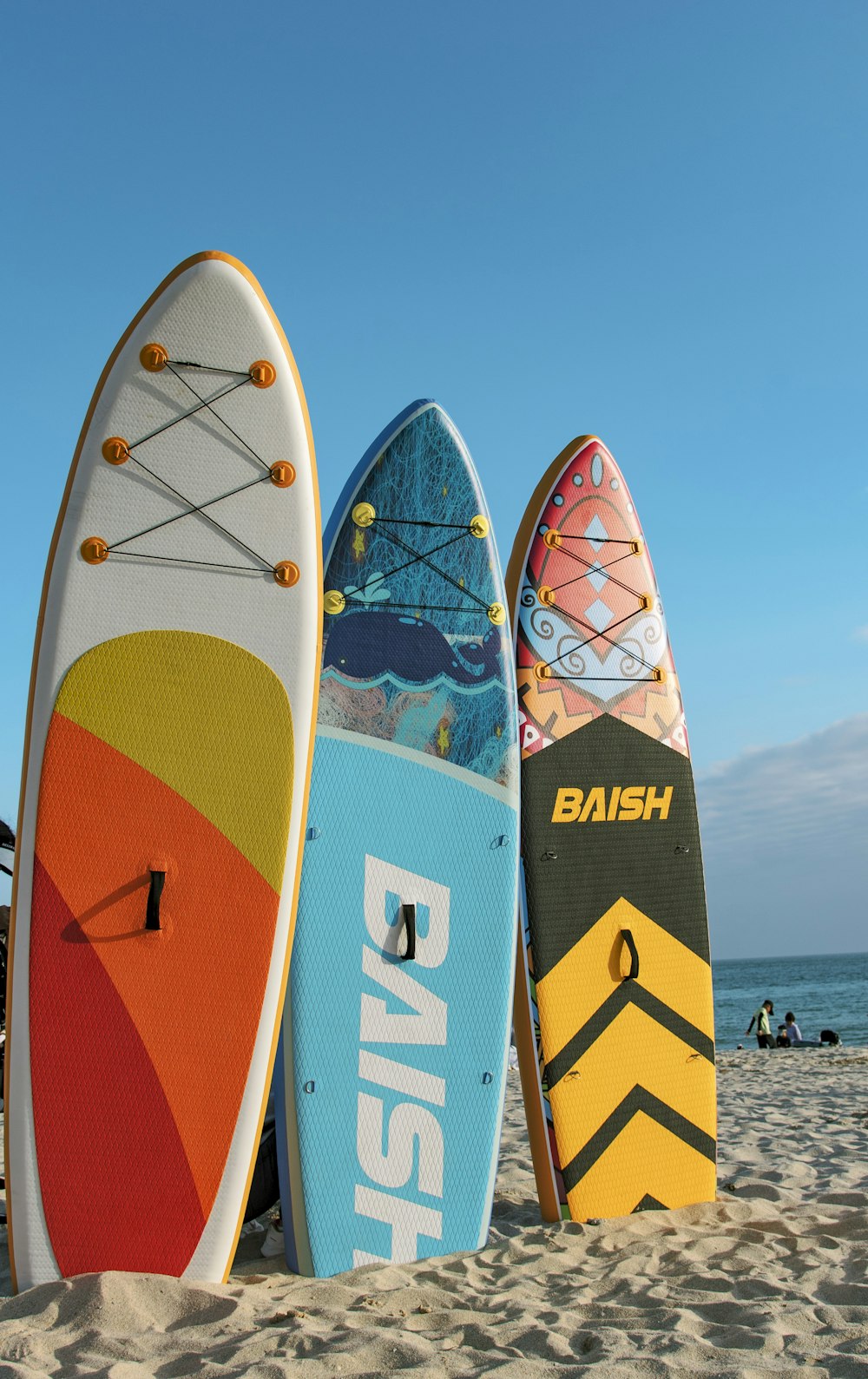 a group of surfboards sitting on top of a sandy beach