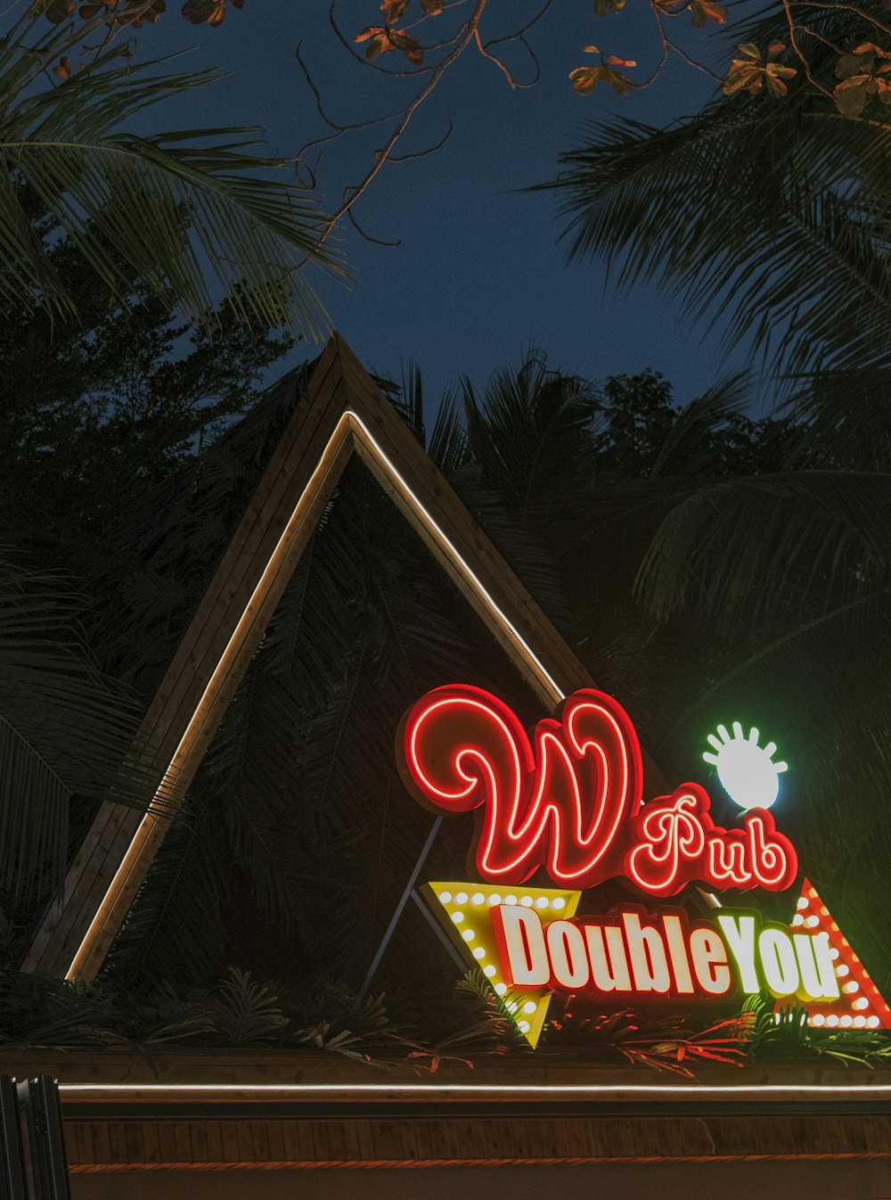 a neon sign is lit up at night