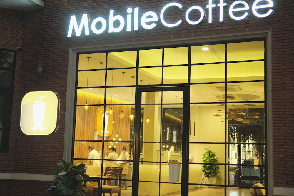 a building with a lit up sign that says mobile coffee