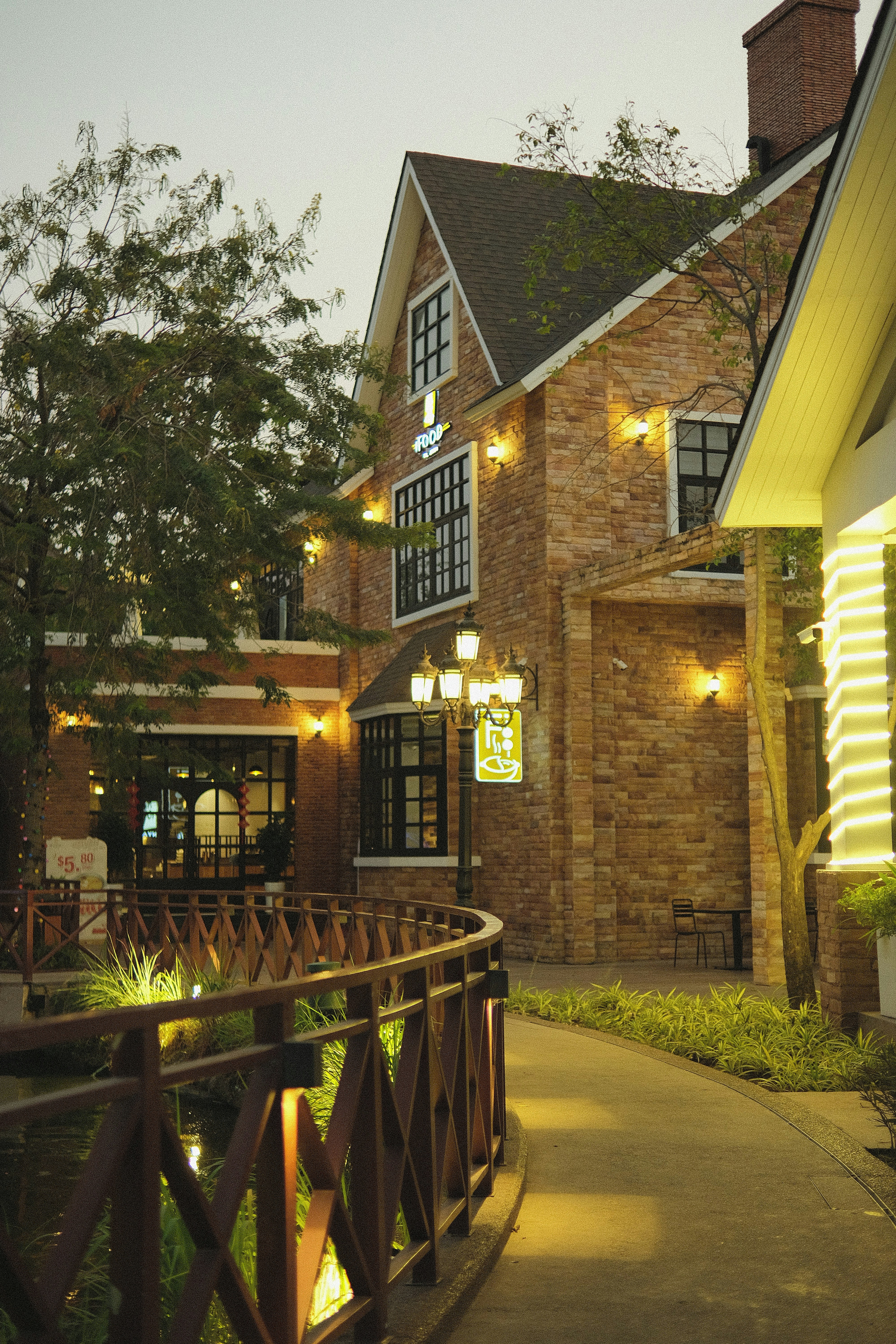 a large brick building with a walkway leading to it