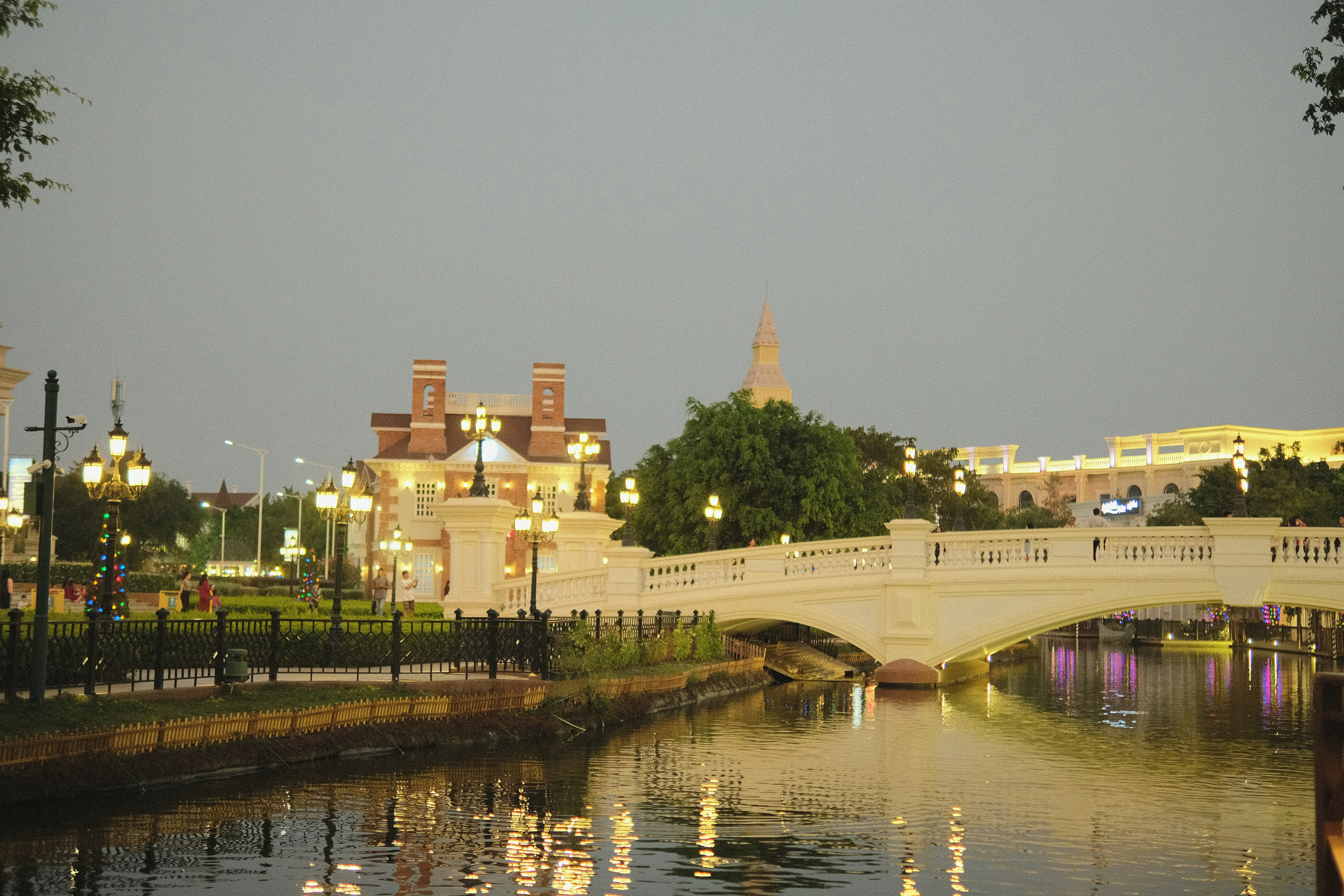 a bridge over a body of water with buildings in the background