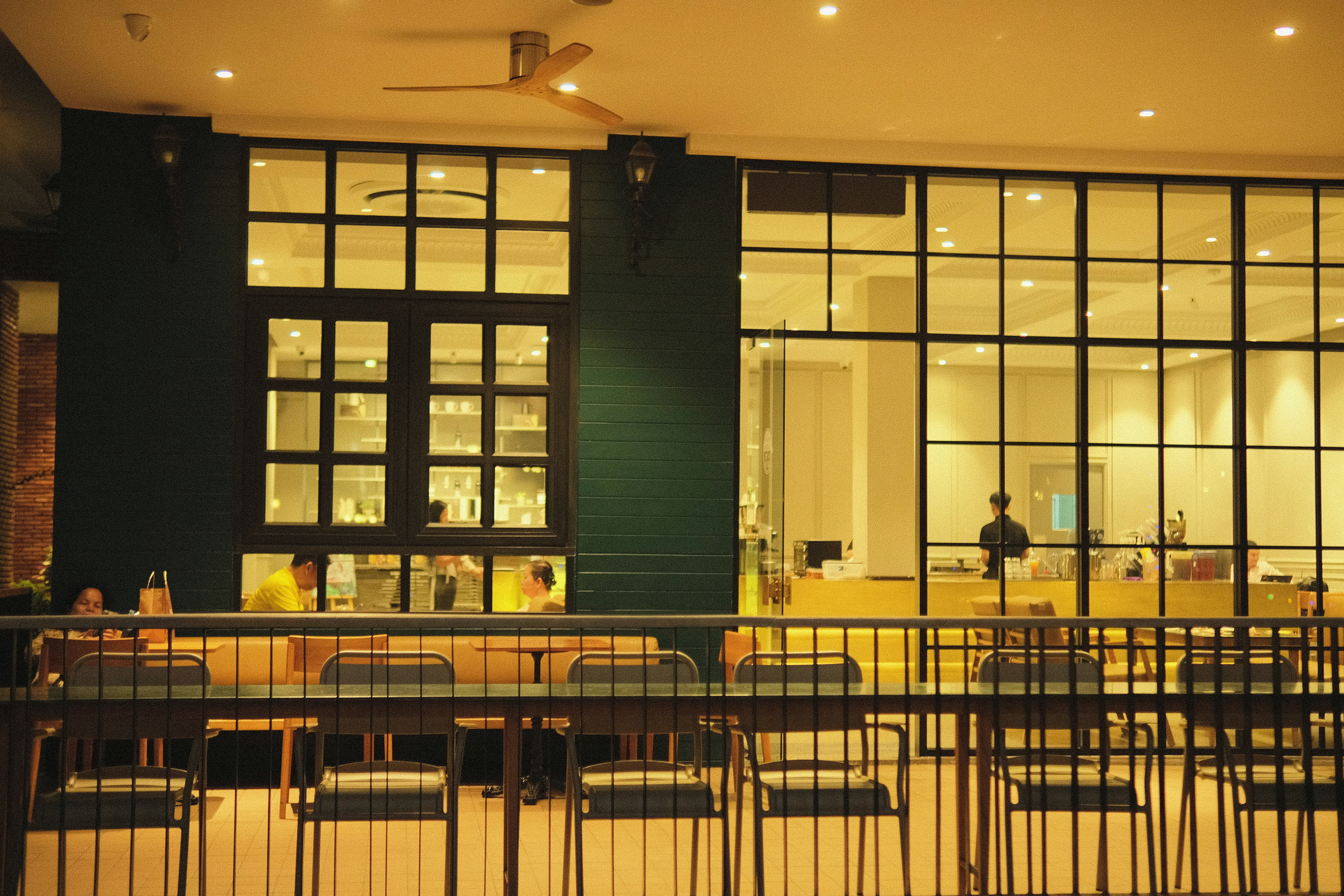 a group of people sitting at tables in front of a building