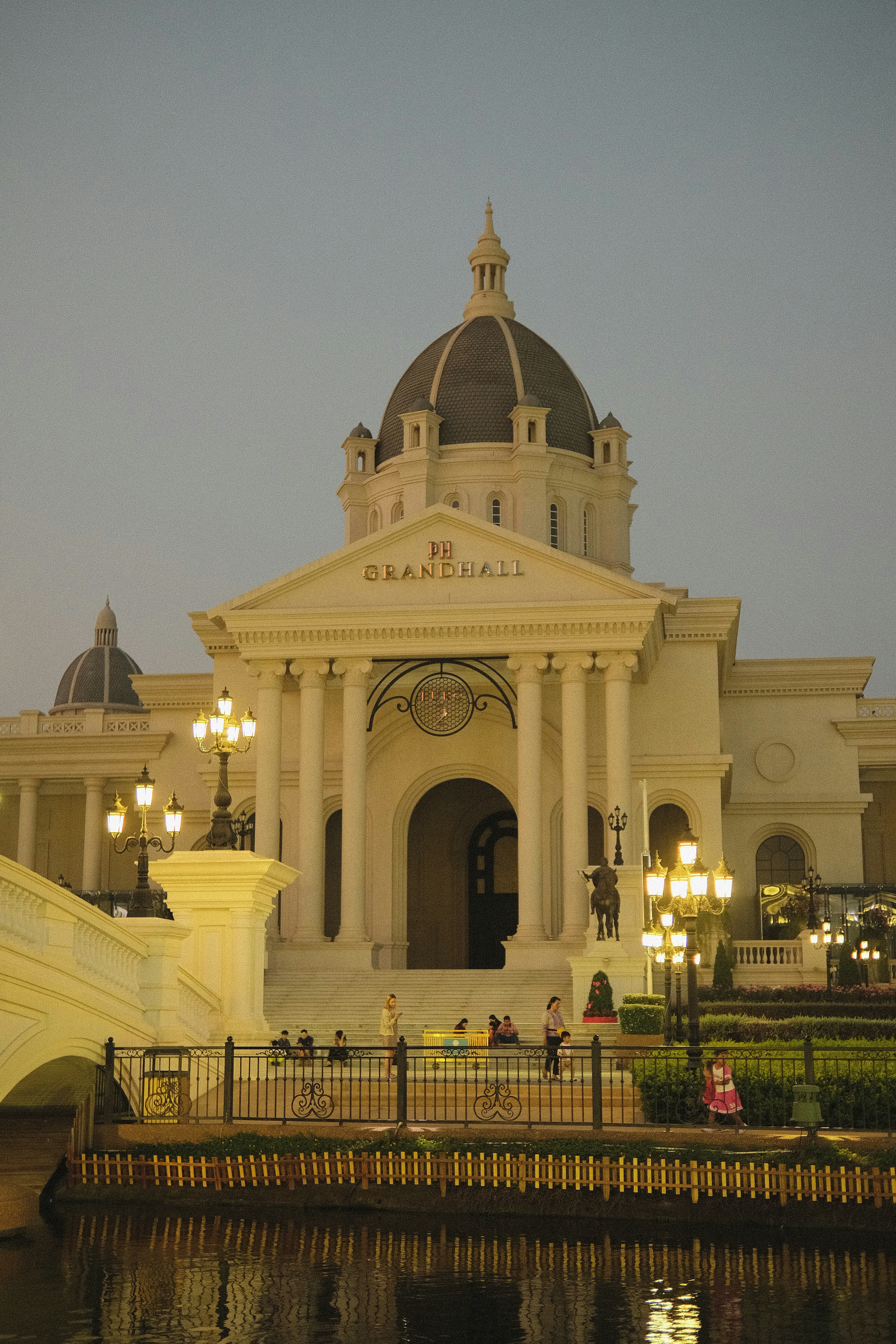 a large white building with a clock on it's face