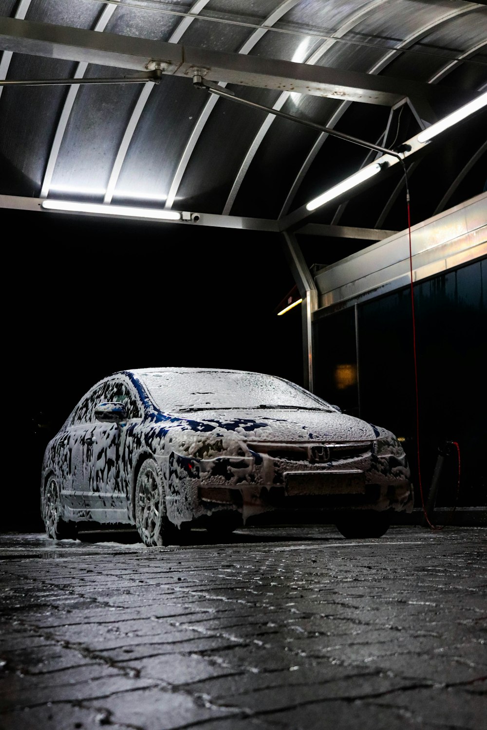 a car parked in a garage covered in snow
