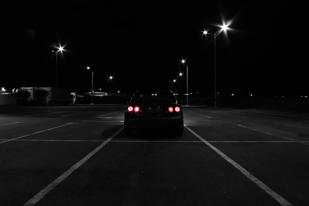 a car parked in a parking lot at night