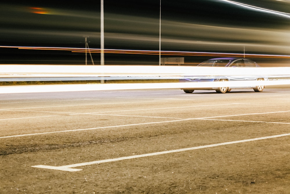 a car driving down a street at night