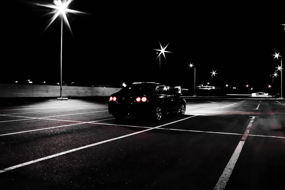 a car is parked in a parking lot at night