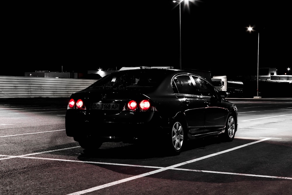 a car parked in a parking lot at night