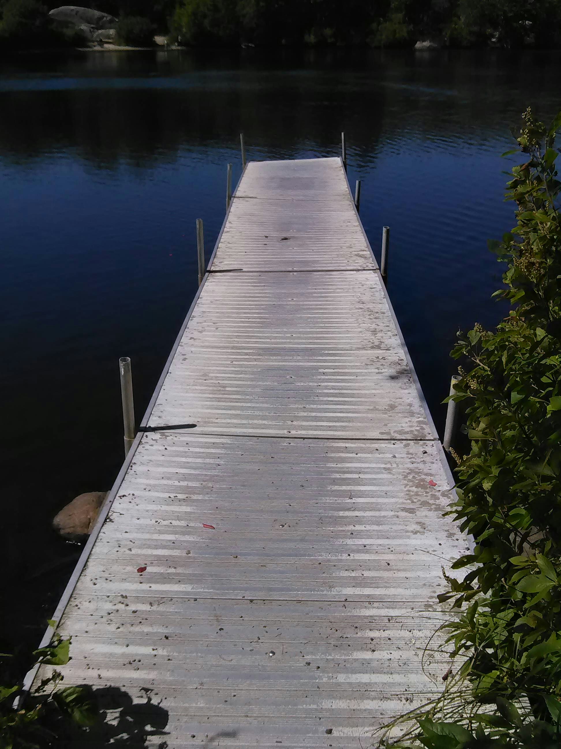 Well-maintained wooden dock over a lake