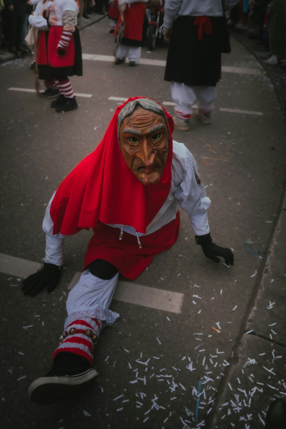 a man with a mask on sitting on the ground