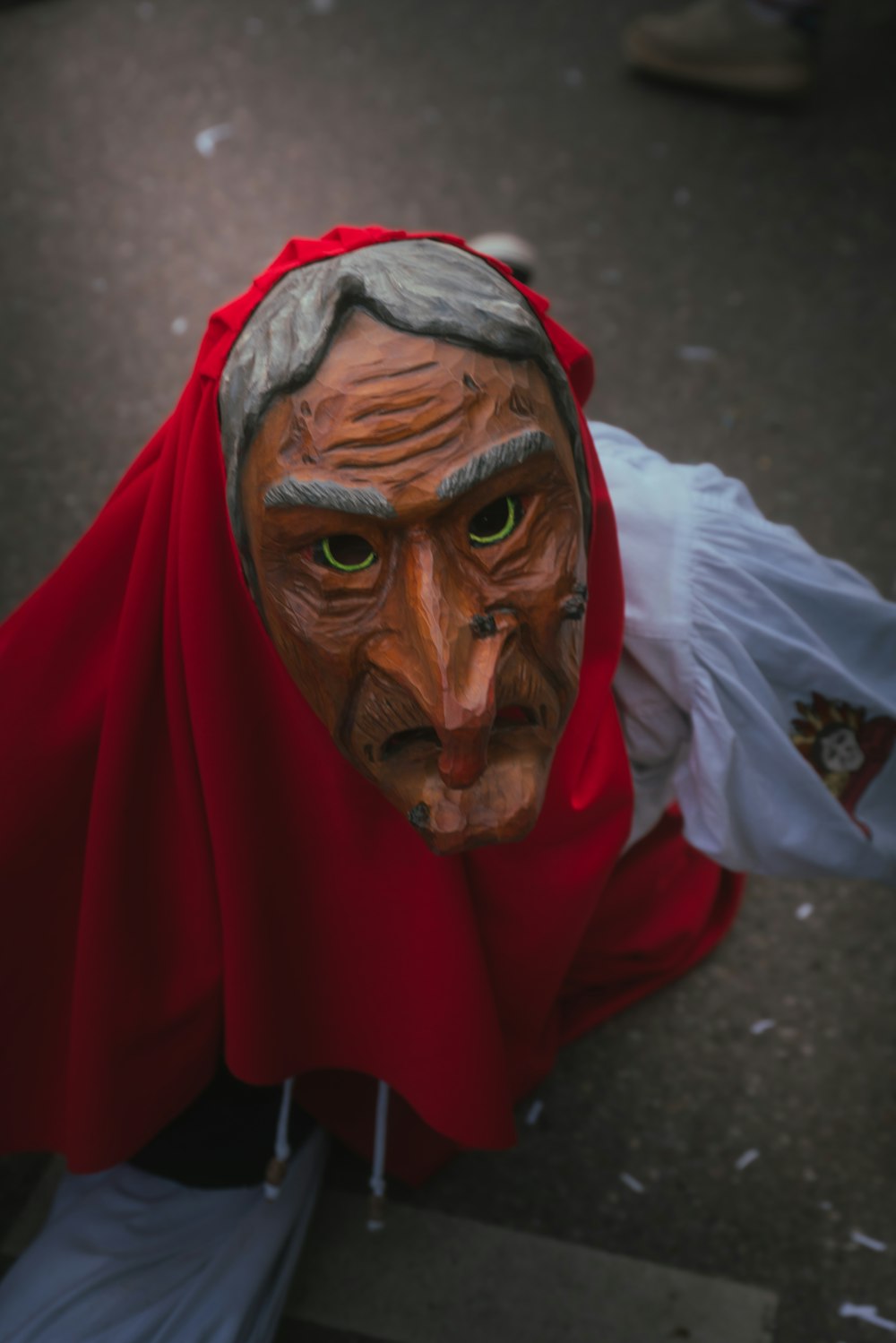 a man wearing a red cape and a mask