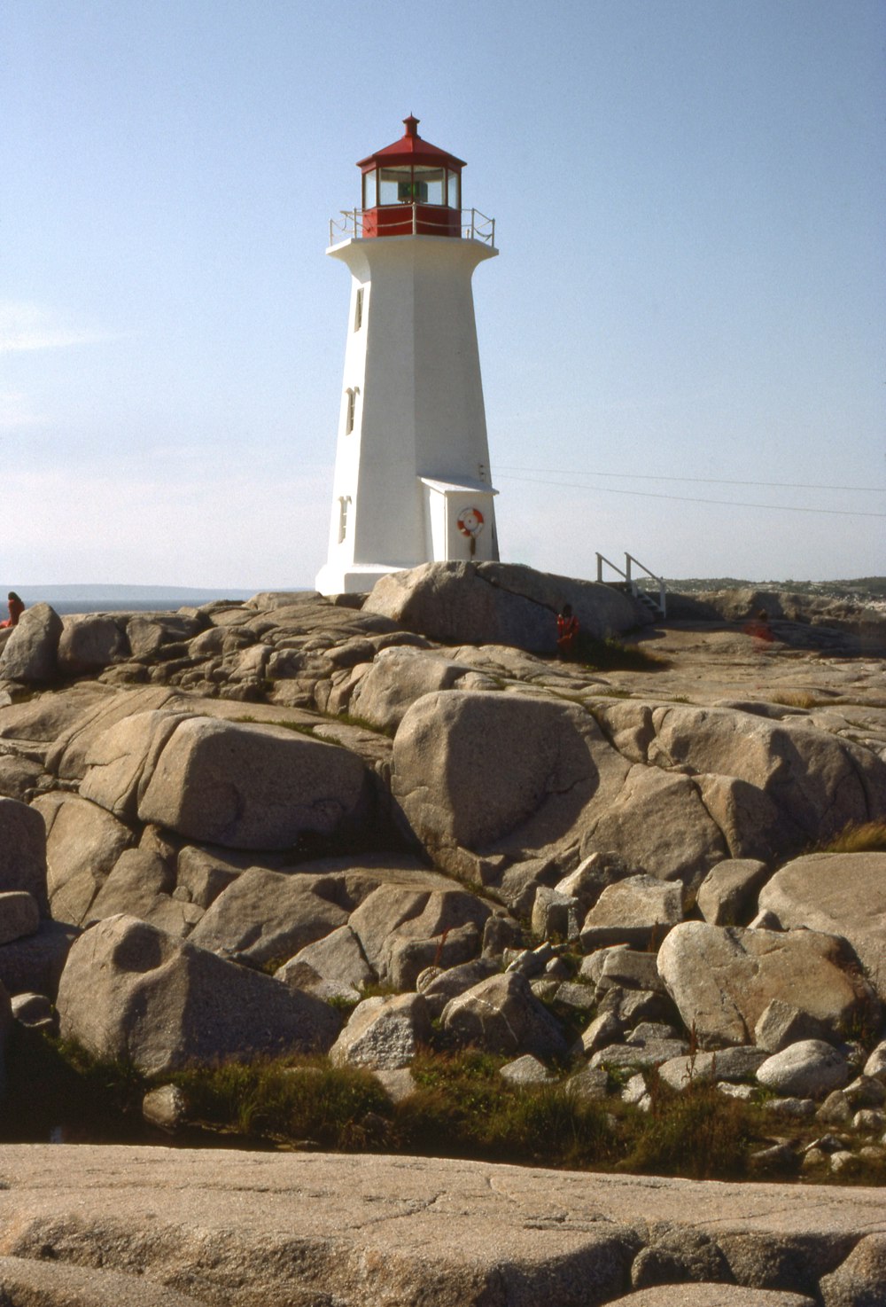 a lighthouse on top of a rocky hill