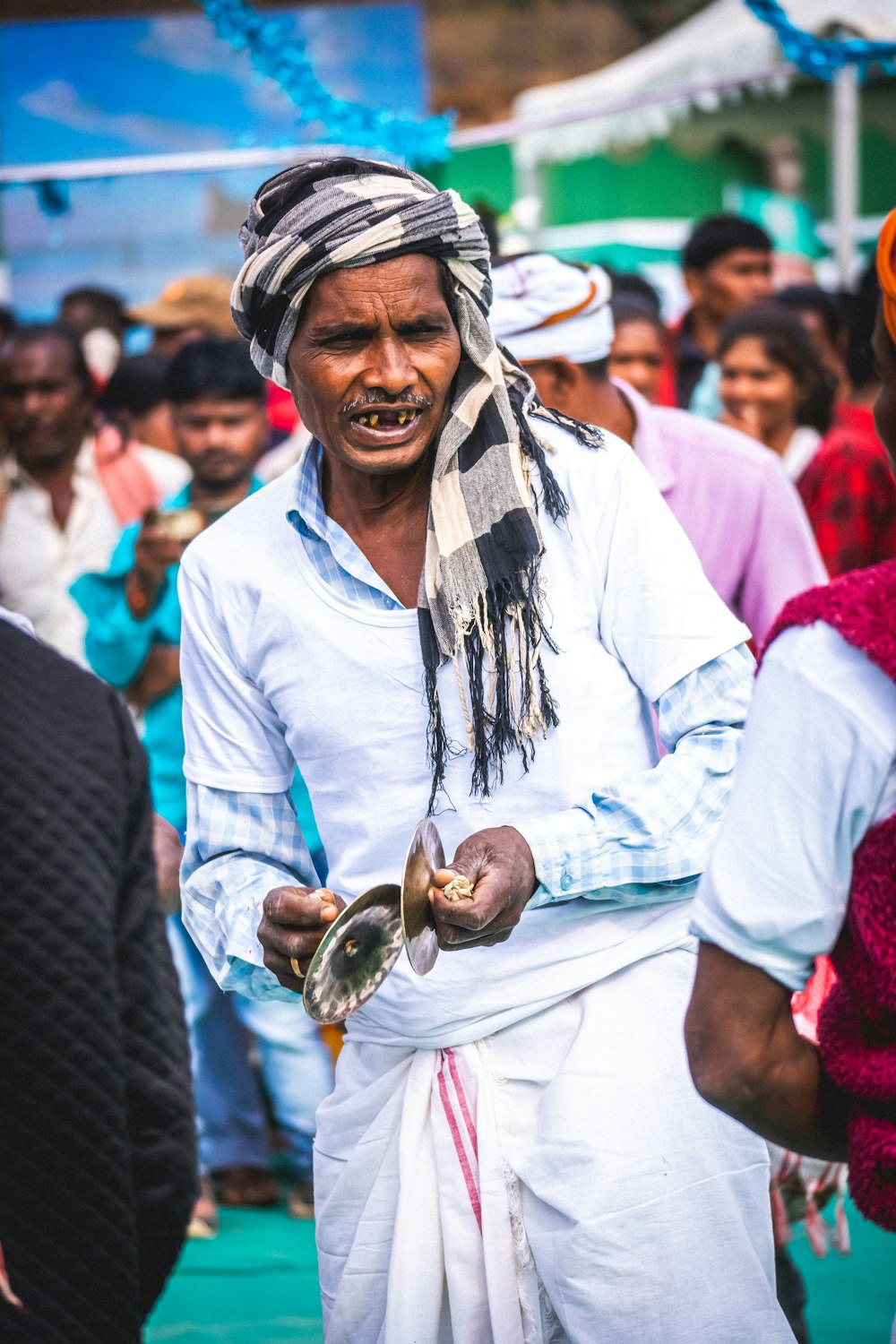 a man in a turban is holding a bowl