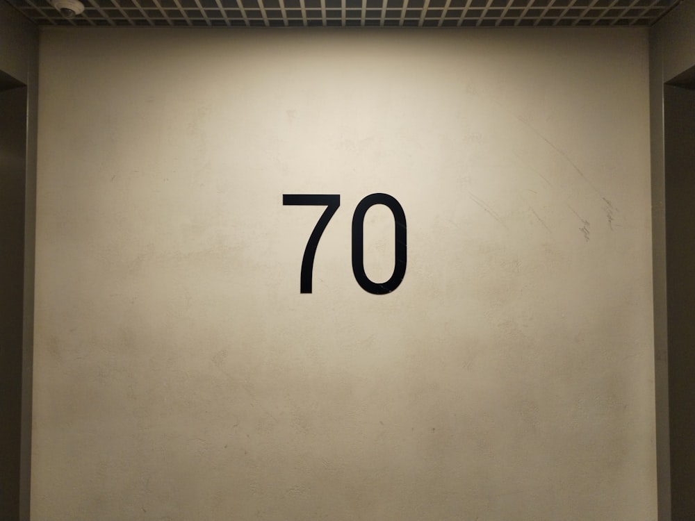 a white wall with a black number seventy on it