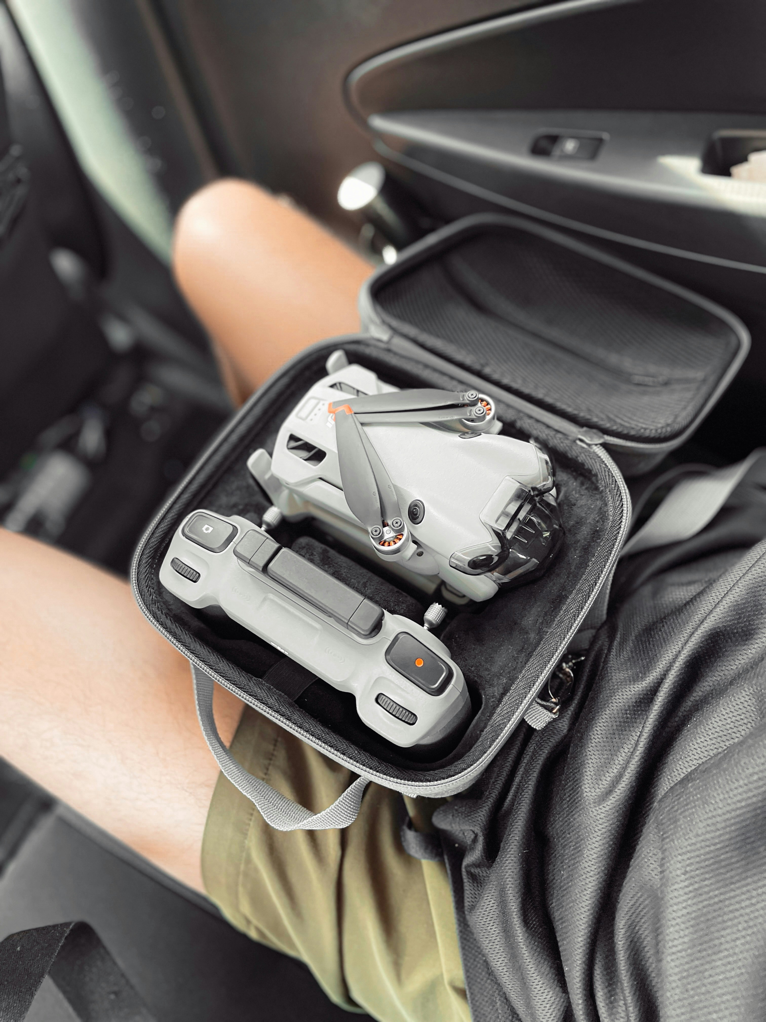 a person holding a case with a video game controller in it