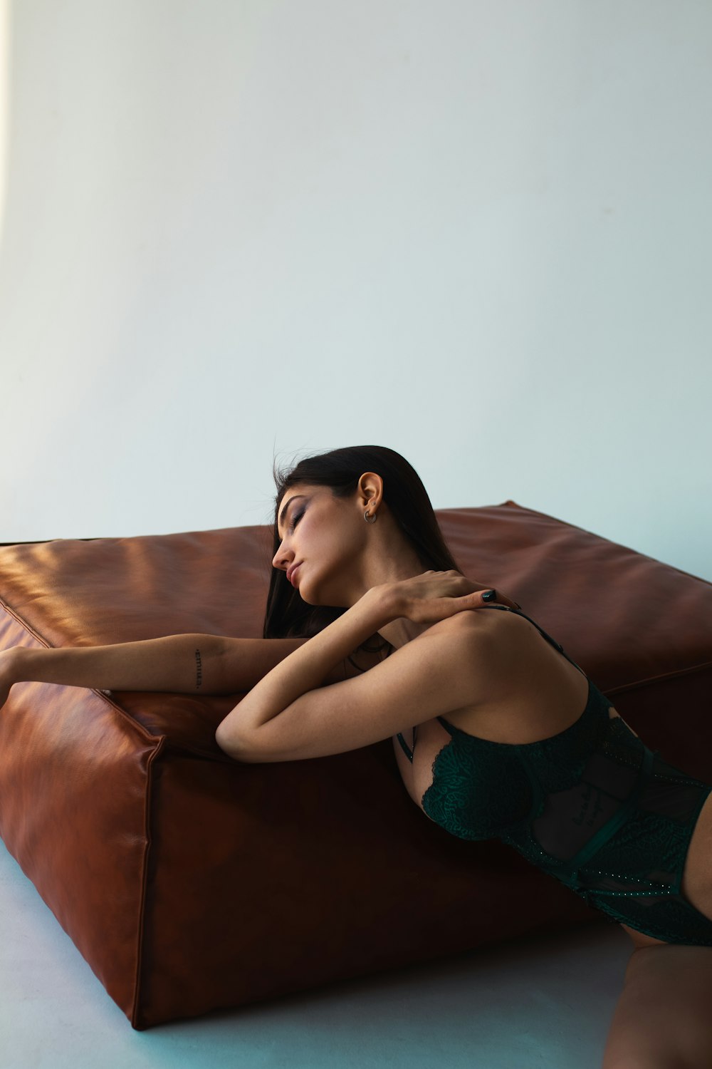 a woman sitting on a brown leather couch