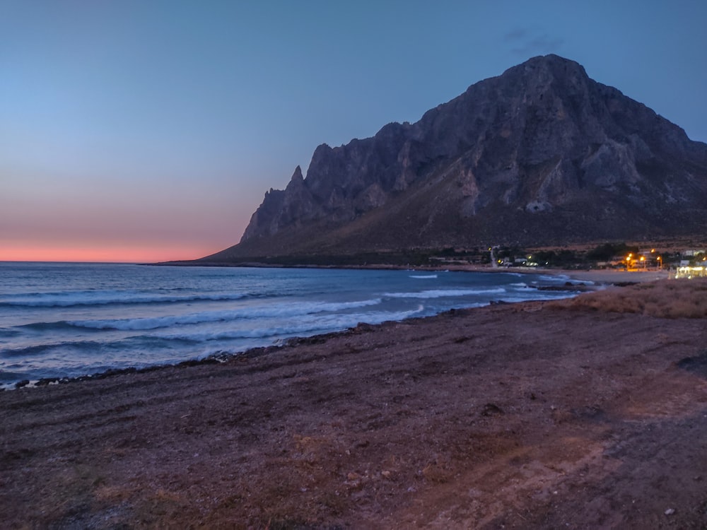 a beach with a mountain in the background