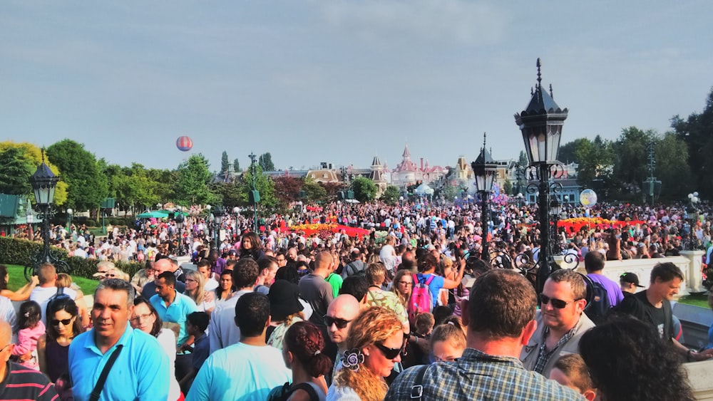 a large group of people standing in a park