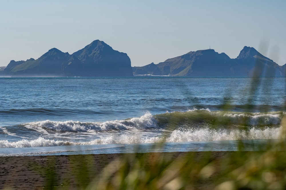 a body of water with mountains in the background