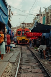 a group of people standing on a train track