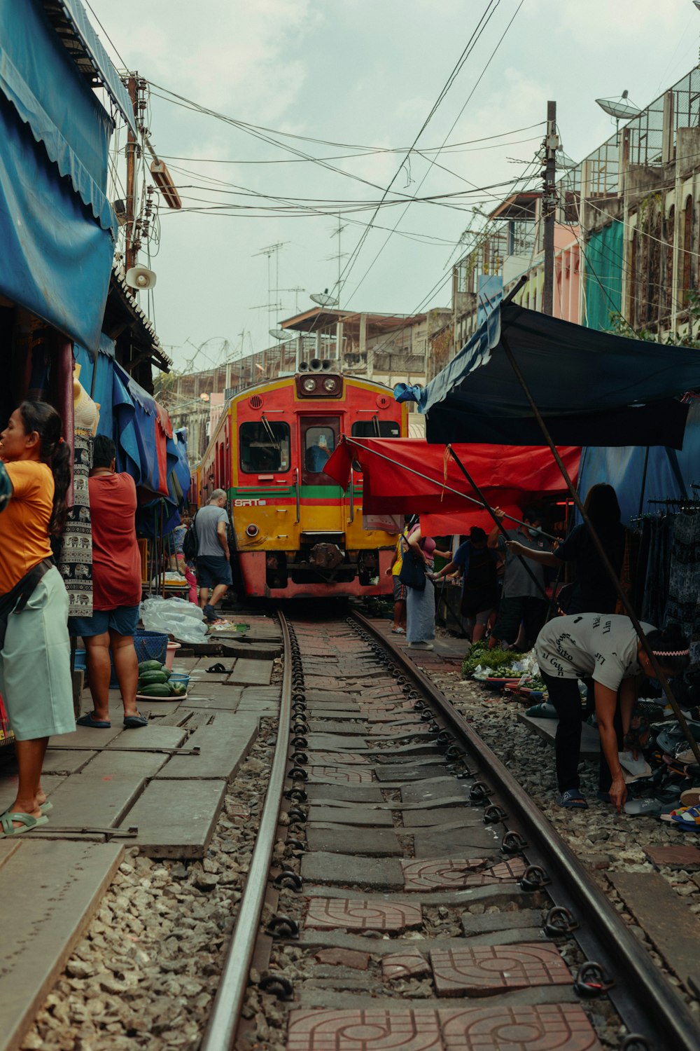 a group of people standing on a train track