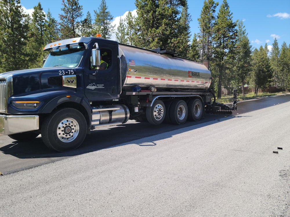 a large tanker truck is parked on the side of the road