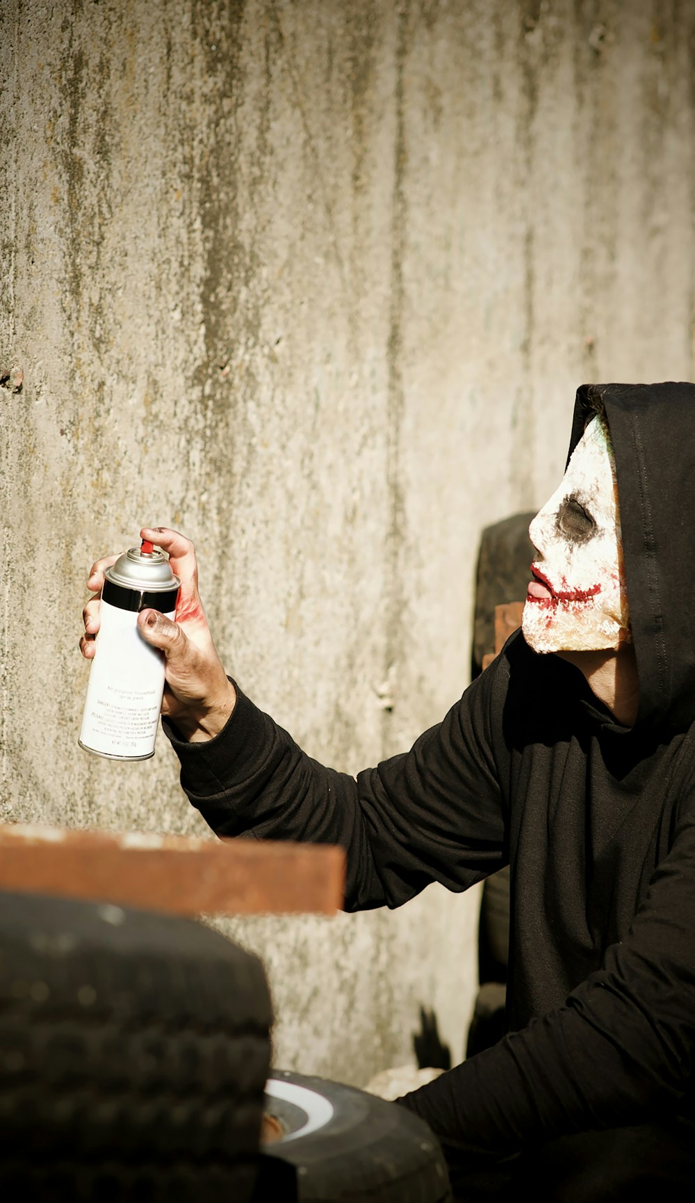 a man in a mask holding a can of beer