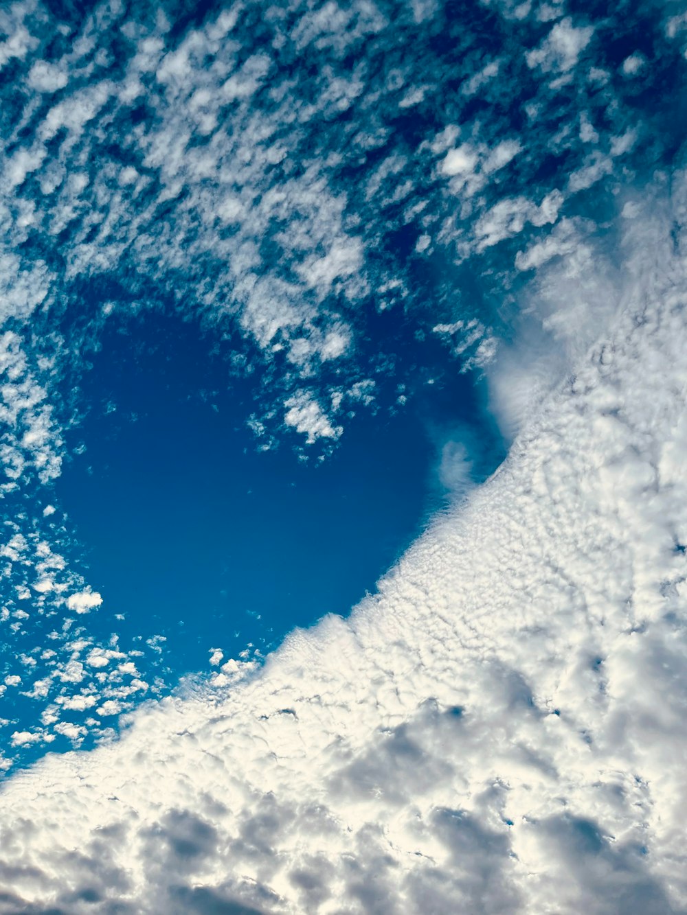 a heart shaped cloud in a blue sky
