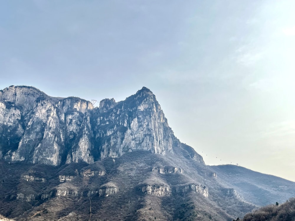 a large mountain with a very tall mountain in the background