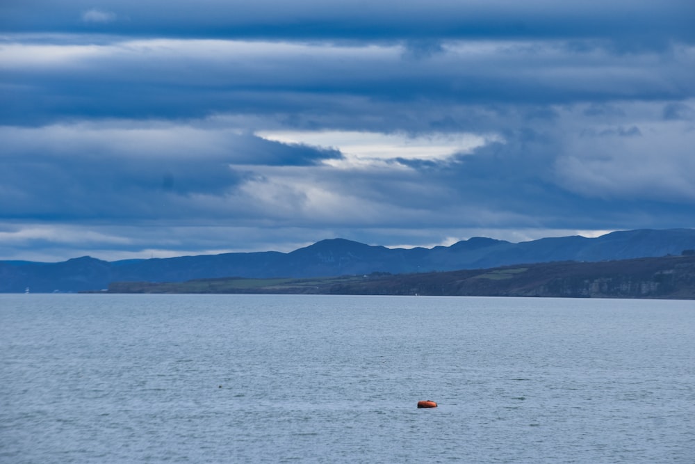 a boat floating on top of a large body of water