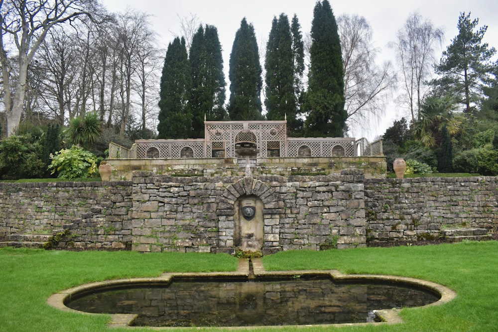 a fountain in the middle of a stone wall