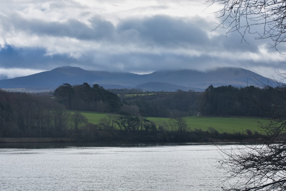 a large body of water with a mountain in the background