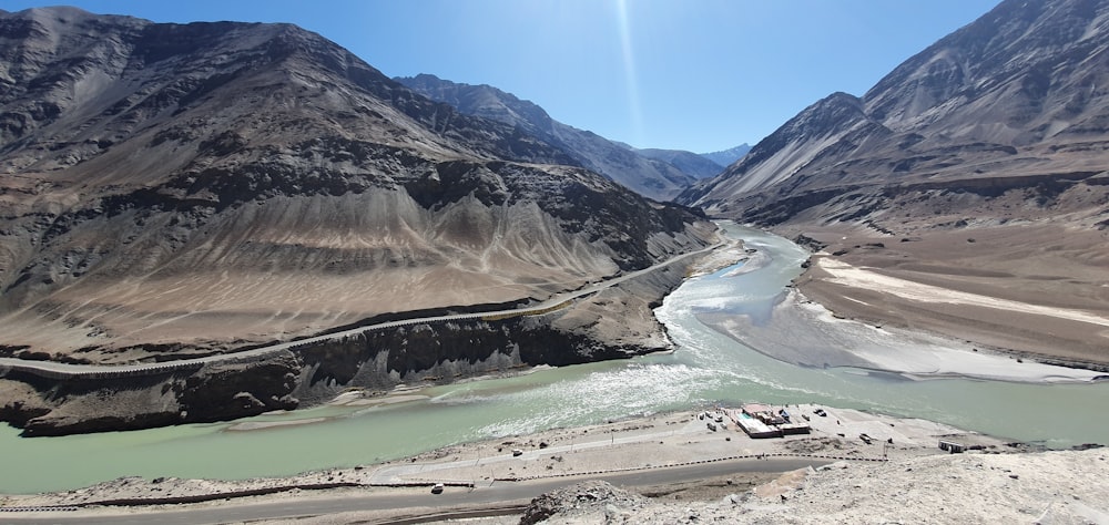 a river running through a valley surrounded by mountains