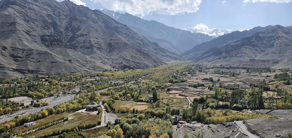 a scenic view of a valley surrounded by mountains