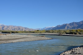 a river with mountains in the background