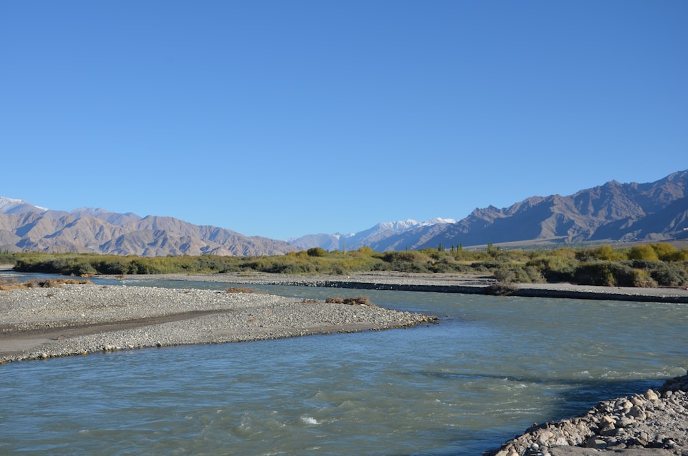 a river with mountains in the background