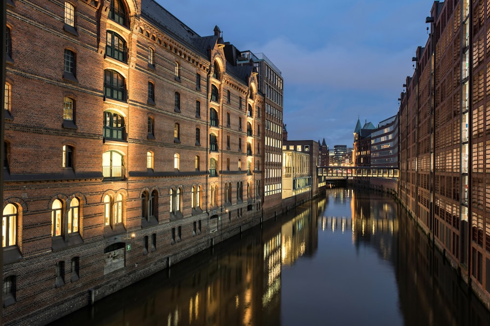 a river running through a city next to tall buildings