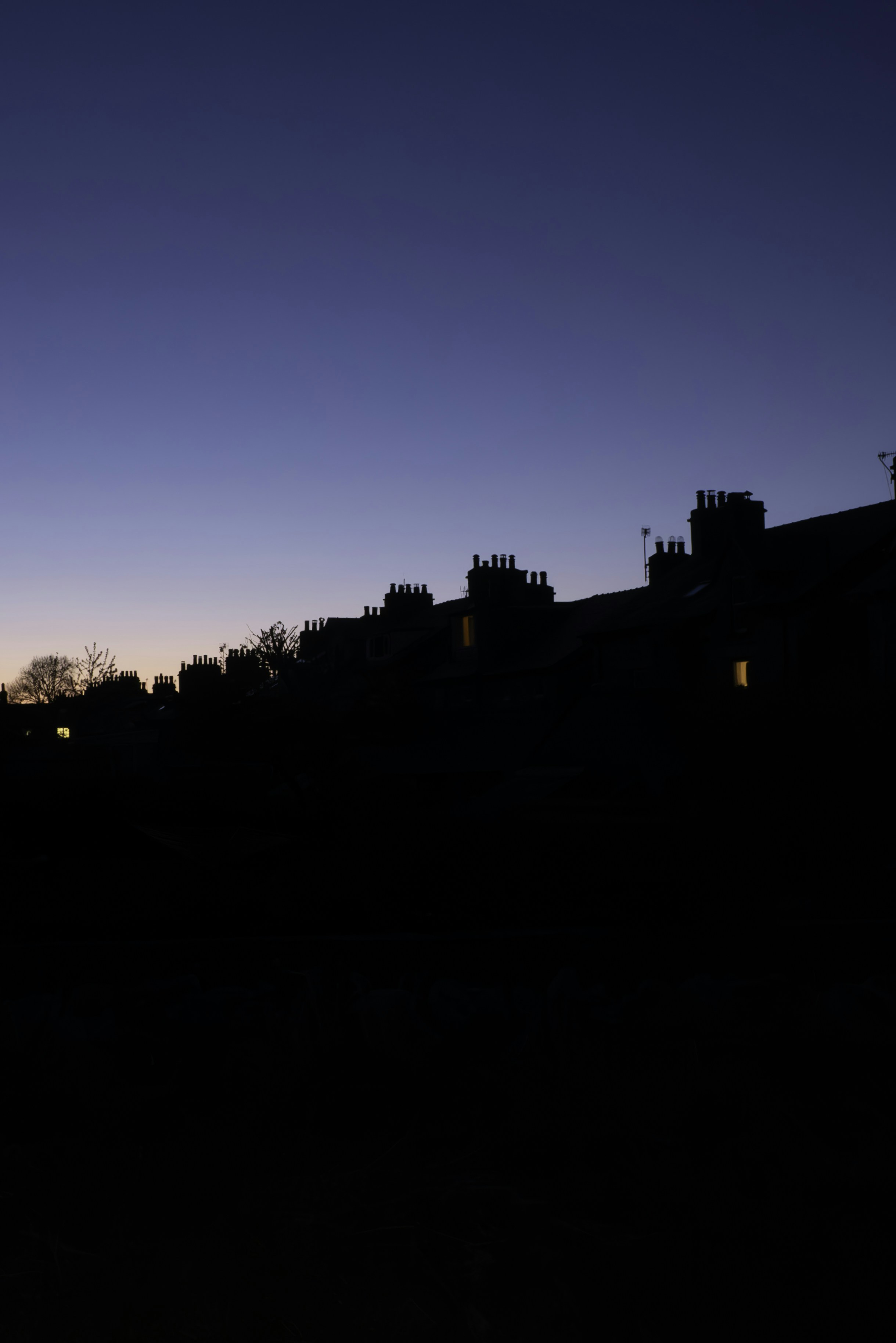 a silhouette of a building with a clock tower in the background