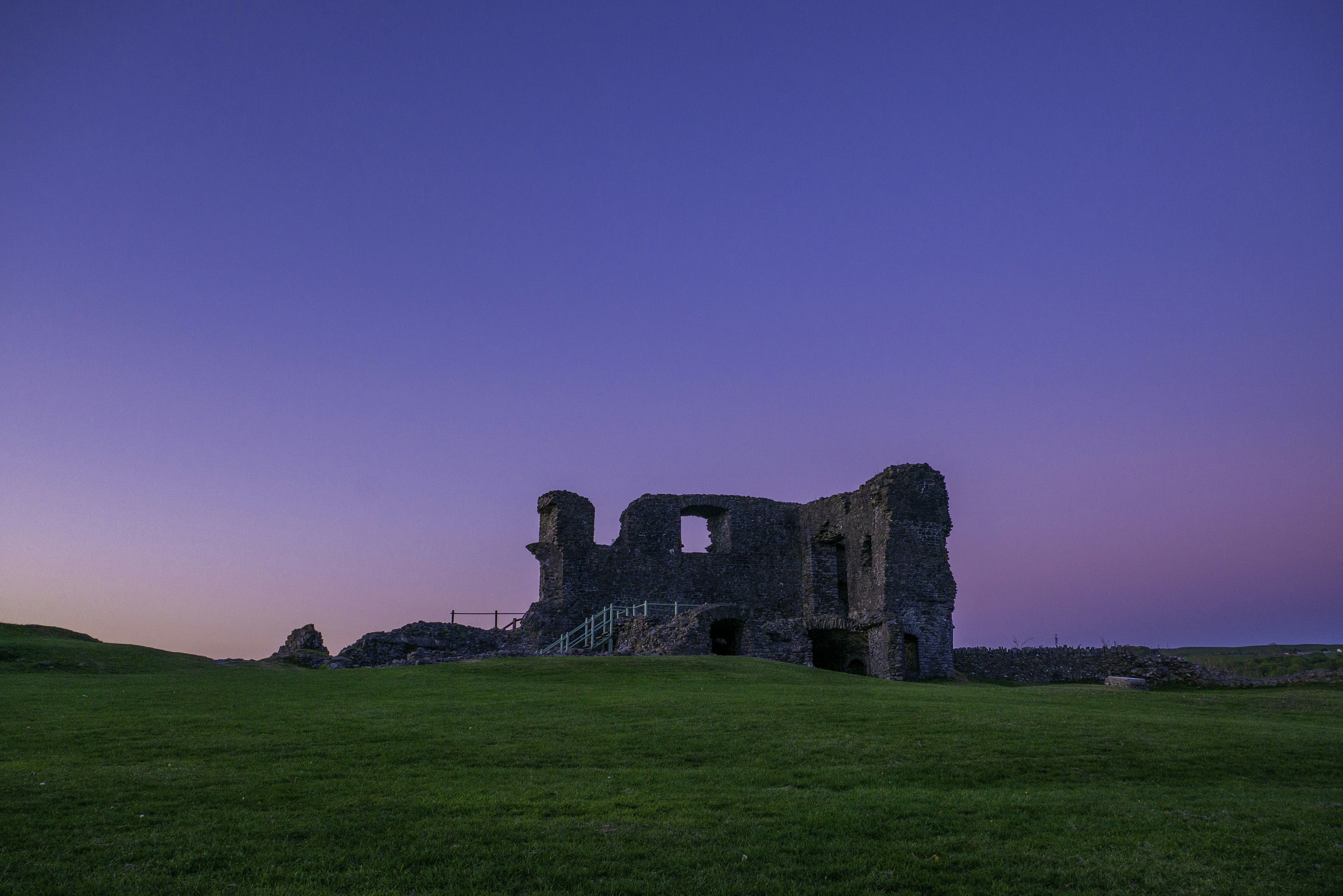 a large building sitting on top of a lush green field